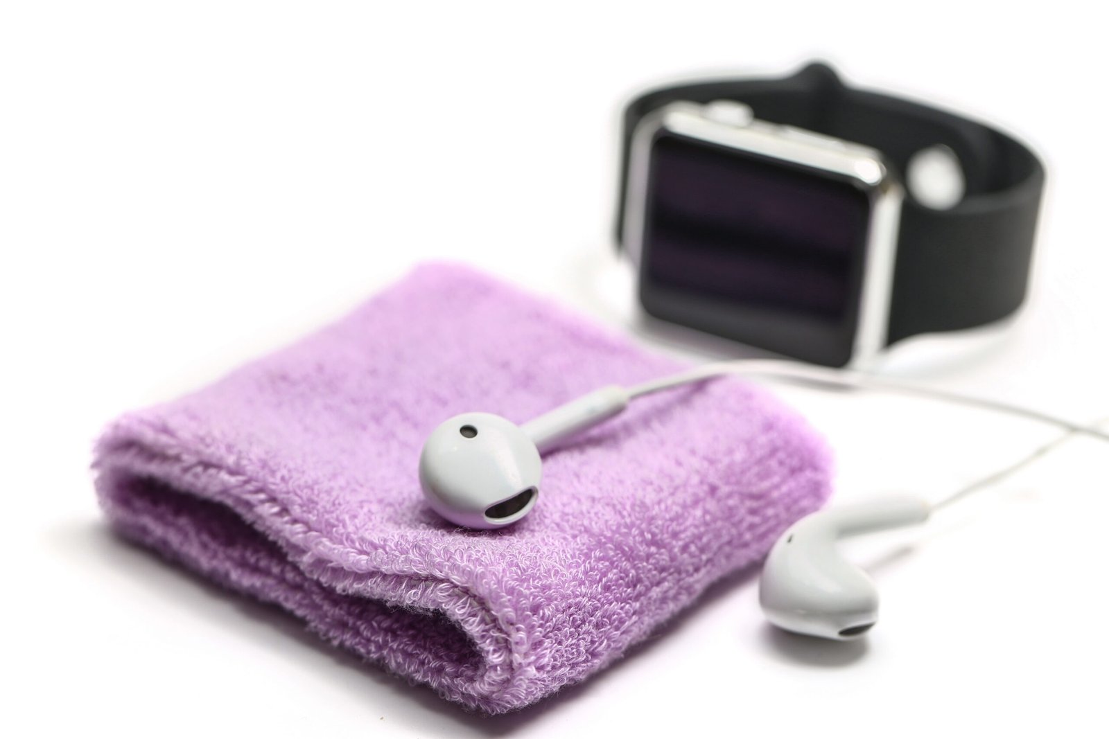 cotton wrist band and earphone on white background